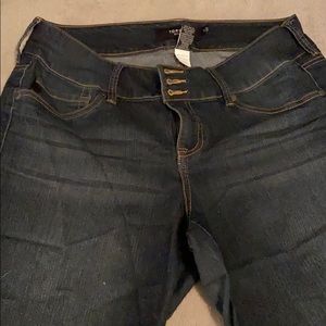 Torrid medium-dark color jean shorts.